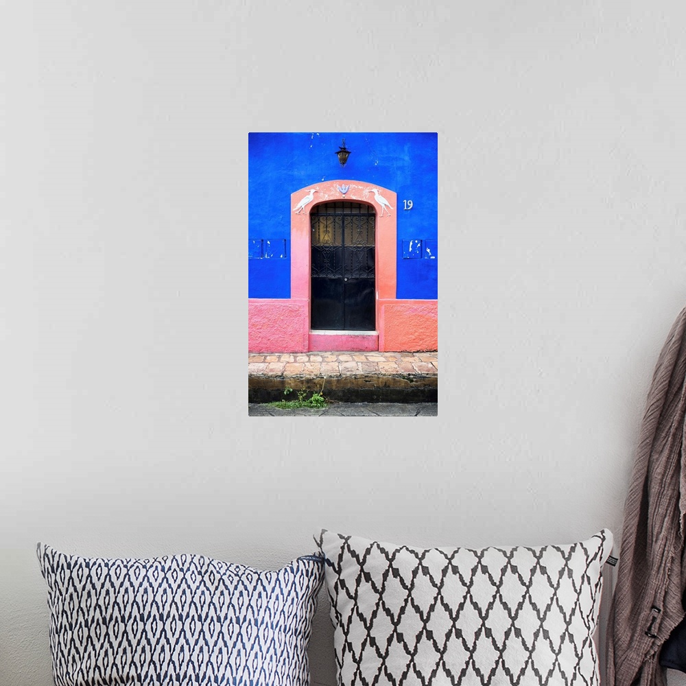 A bohemian room featuring Photograph of the blue and pink exterior to a building highlighting the doorway. From the Viva Me...
