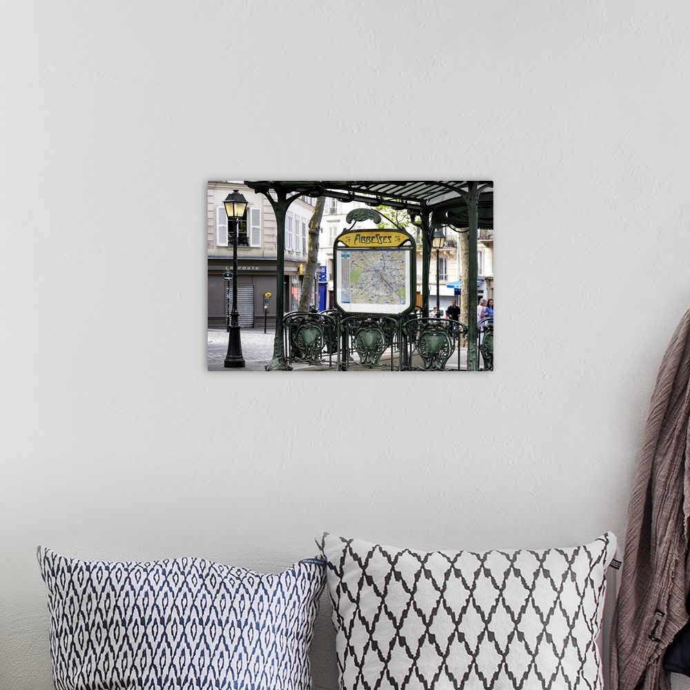 A bohemian room featuring A photograph of the Abbesses subway station sign in Paris.