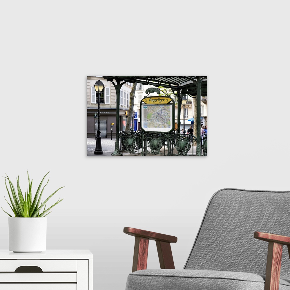 A modern room featuring A photograph of the Abbesses subway station sign in Paris.