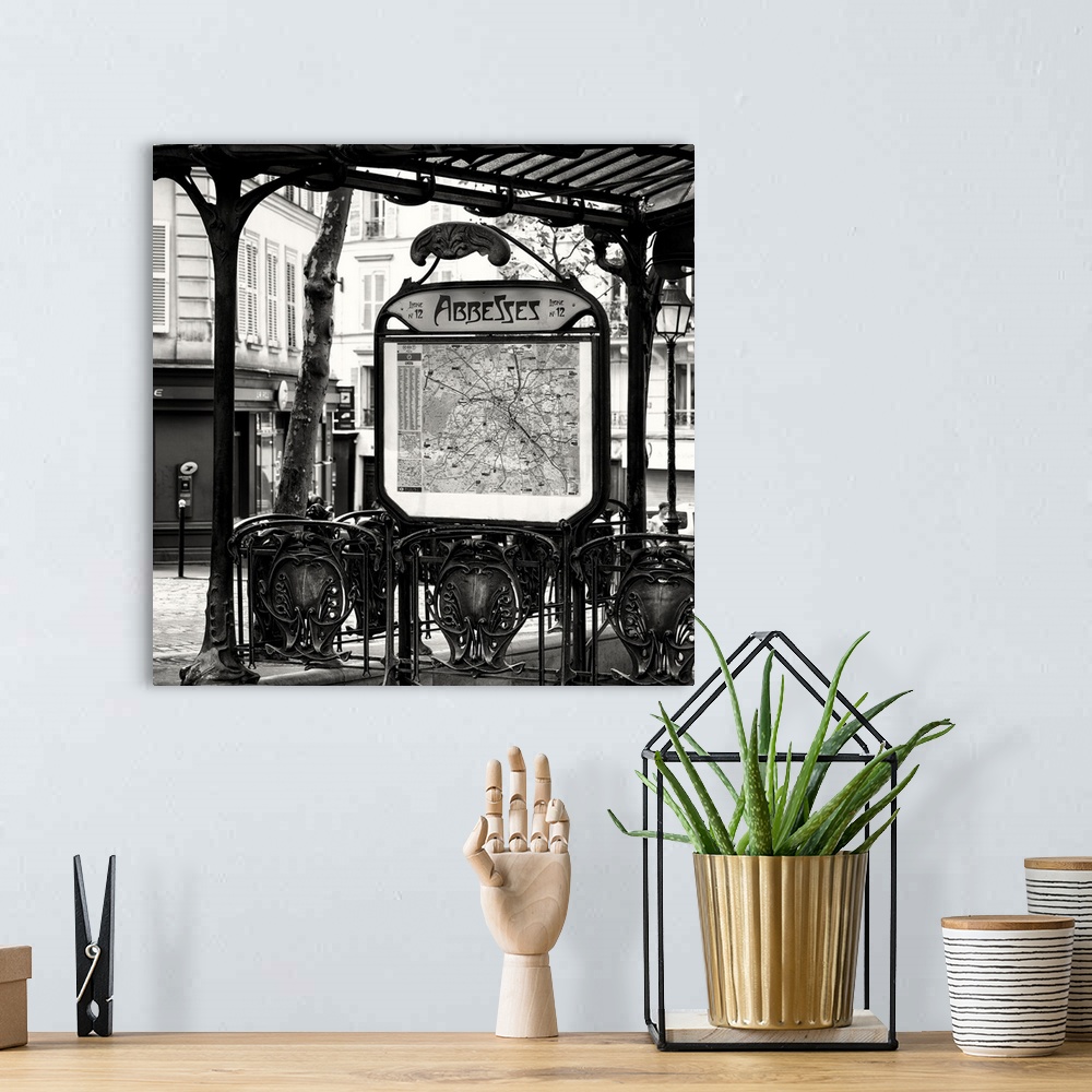 A bohemian room featuring A black and white photograph of the Abbesses subway station sign in Paris.