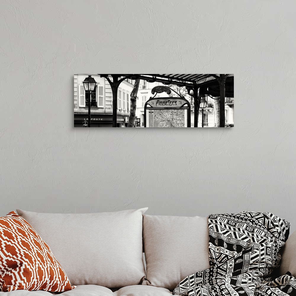 A bohemian room featuring A black and white photograph of the Abbesses subway station sign in Paris.