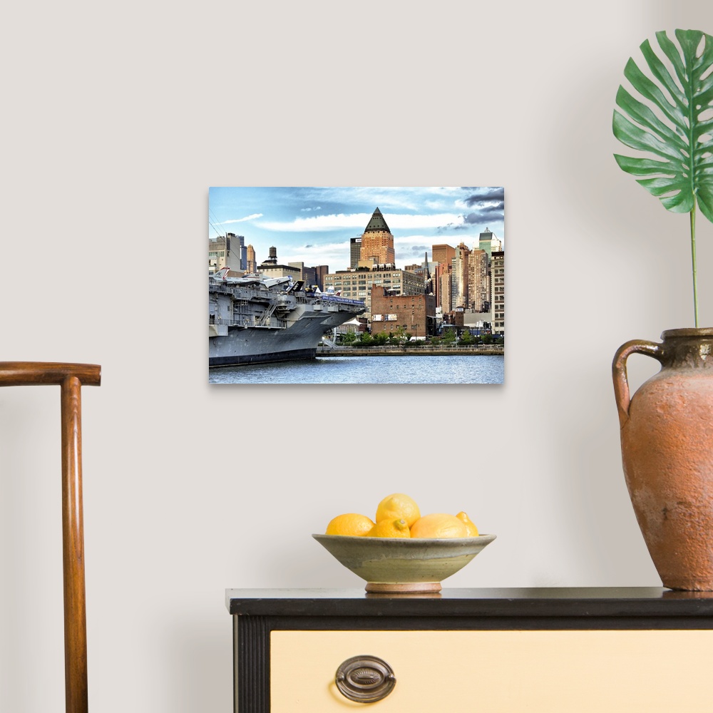 A traditional room featuring Fine art photo of a large military ship in New York harbor.