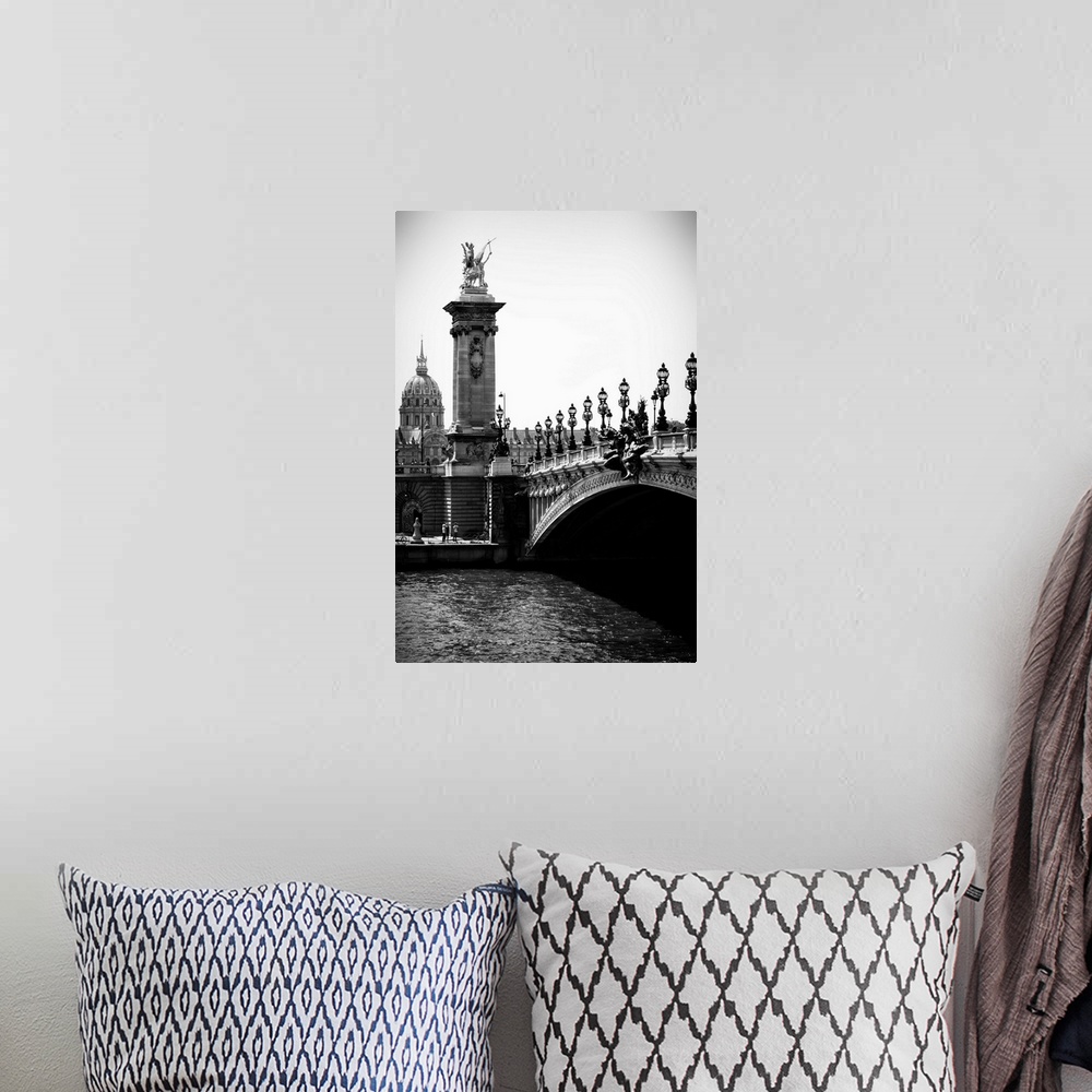 A bohemian room featuring A black and white photograph of the Alexandre III bridge in Paris.