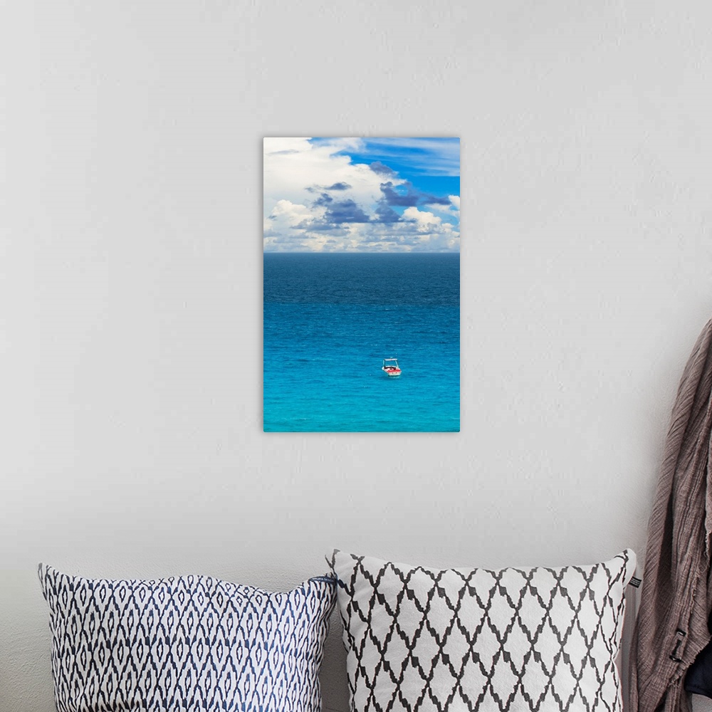 A bohemian room featuring Photograph of a single boat on the clear blue sea. From the Viva Mexico Collection.
