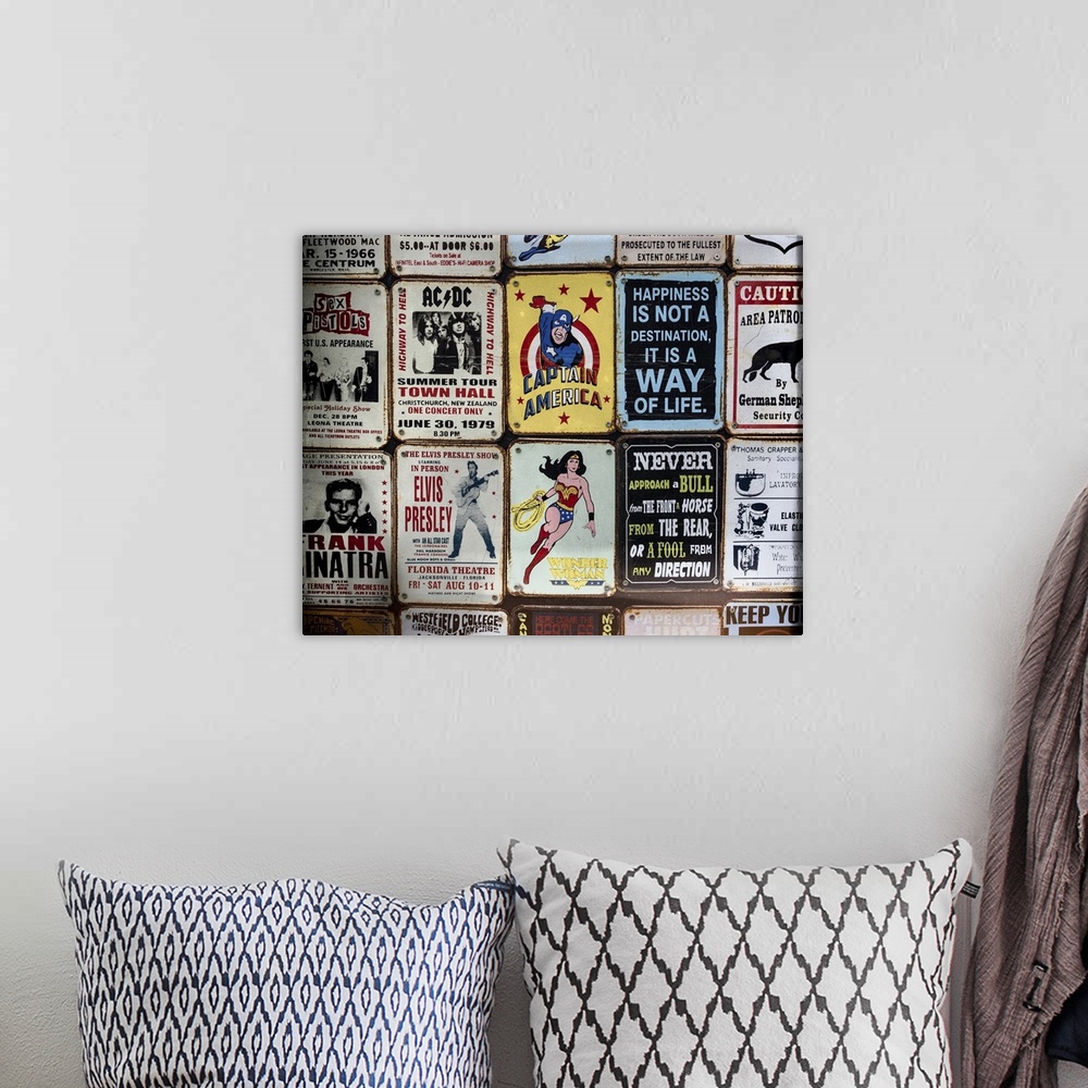 A bohemian room featuring Souvenir metal signs for sale in London, featuring superheroes, sarcastic sayings, and popular mu...
