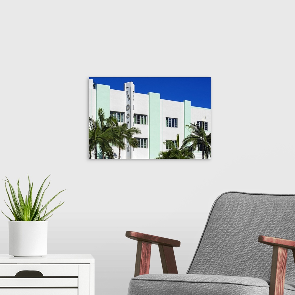 A modern room featuring Palm trees frame an Art Deco style building in Miami, Florida.