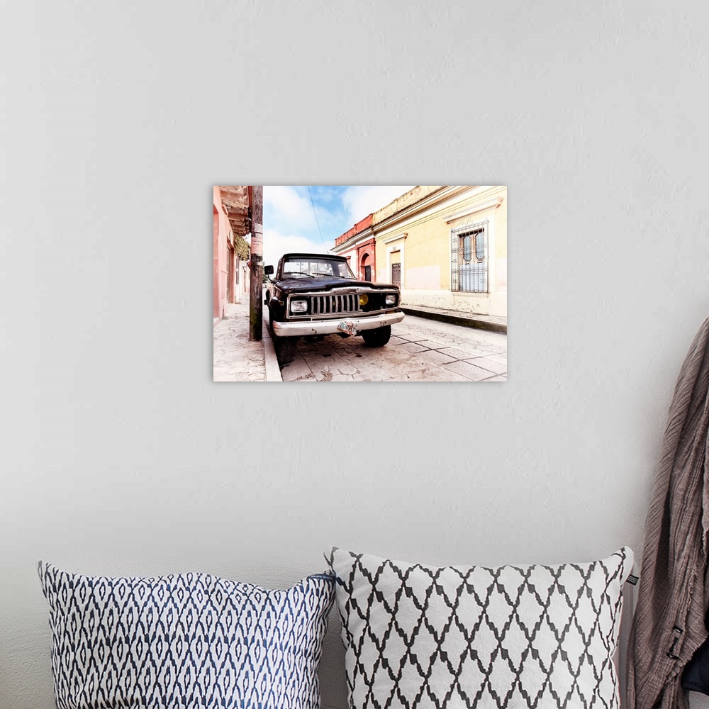 A bohemian room featuring Washed out photograph of an old black Jeep parked on the side of a colorful street in Mexico. Fro...