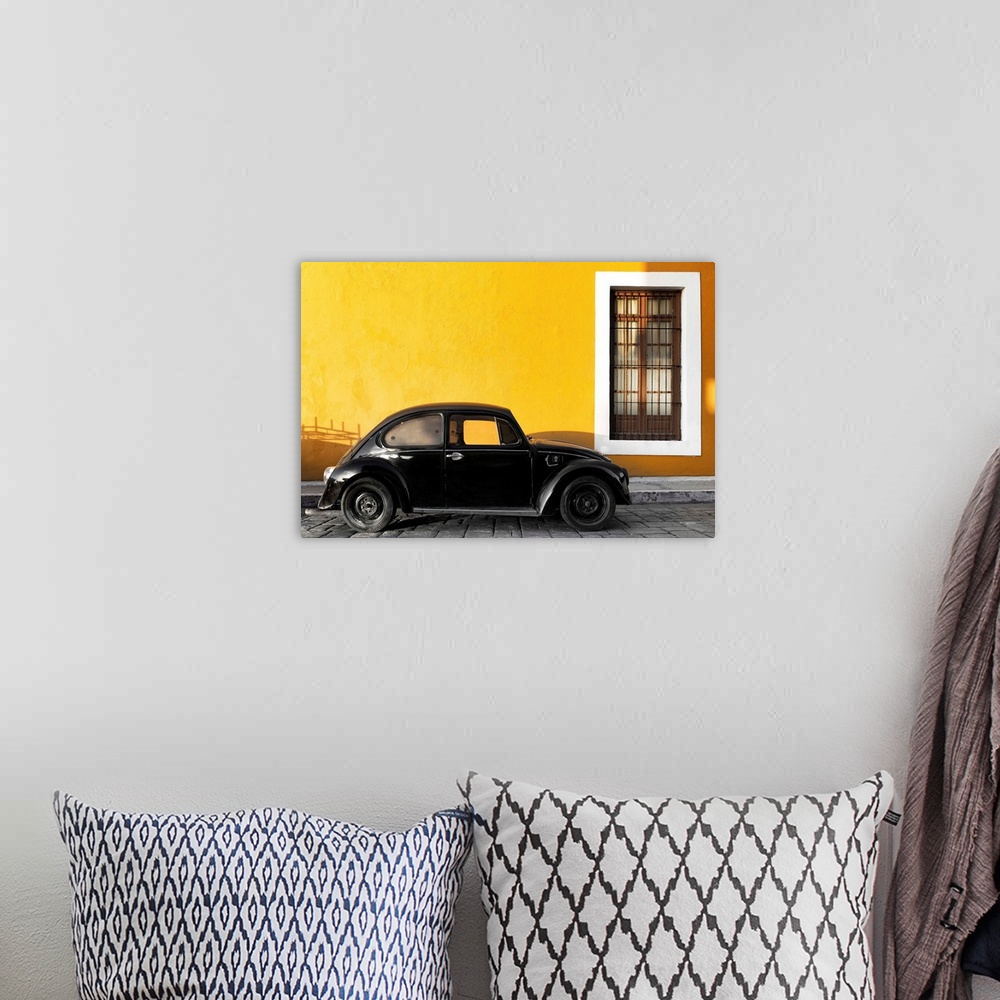 A bohemian room featuring Photograph of a black Volkswagen Beetle parked on the street in front of a gold exterior wall. Fr...