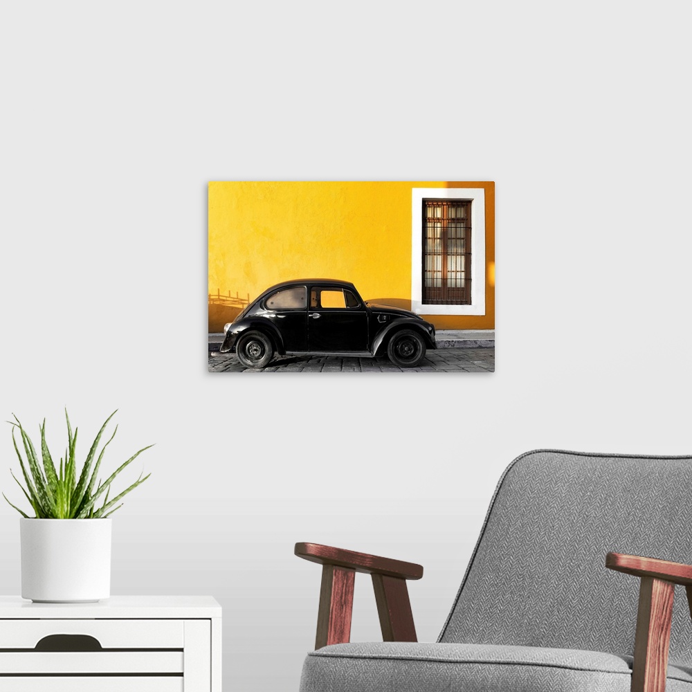 A modern room featuring Photograph of a black Volkswagen Beetle parked on the street in front of a gold exterior wall. Fr...