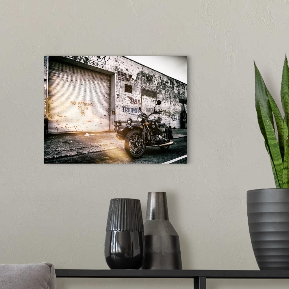 A modern room featuring A photograph of a motorcycle with a side car in New York City.