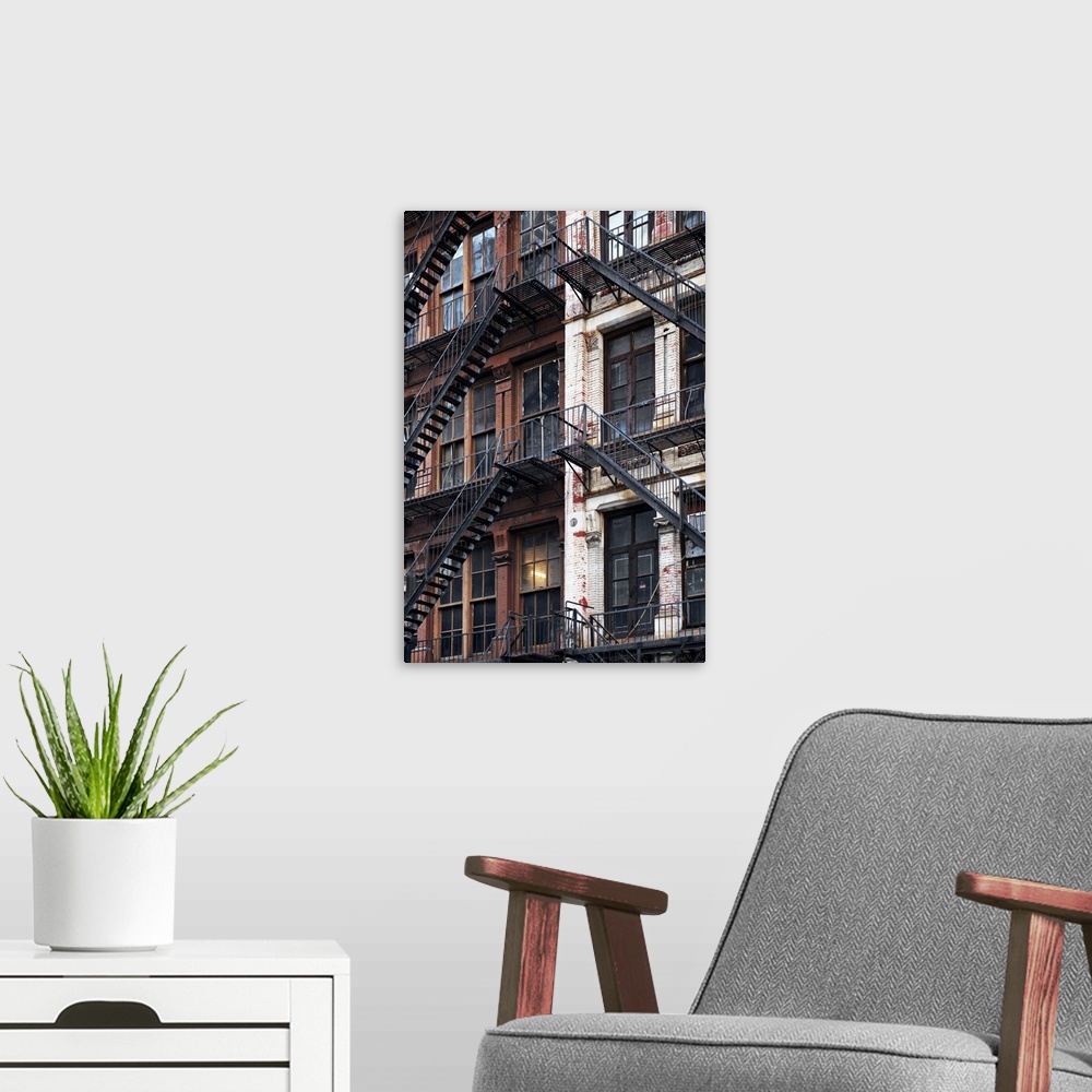 A modern room featuring Criss-crossing fire escapes create an abstract image on the sides of a New York building.