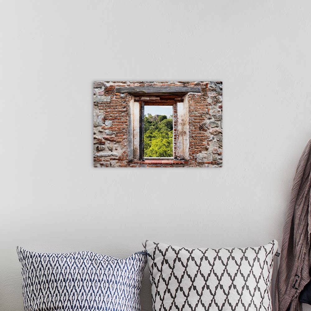 A bohemian room featuring View of the ancient Mayan City of Calakmul, Mexico, framed through a stony, brick window. From th...