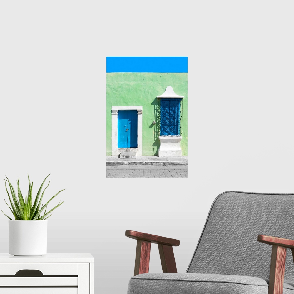 A modern room featuring Photograph of a green exterior wall with a blue door and window in Campeche, Mexico. From the Viv...