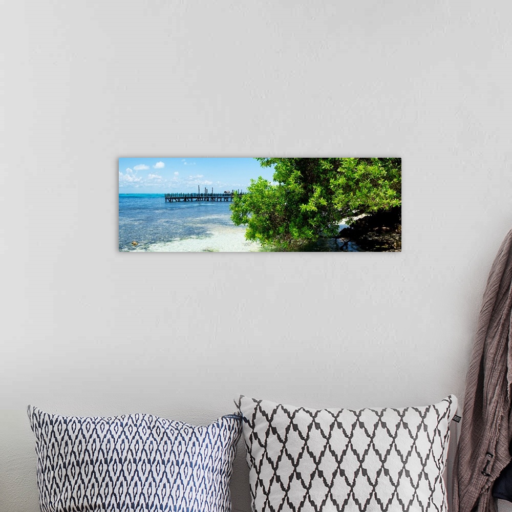 A bohemian room featuring Panoramic photograph of the beautiful, clear blue Caribbean coastline with a pier in the distance...
