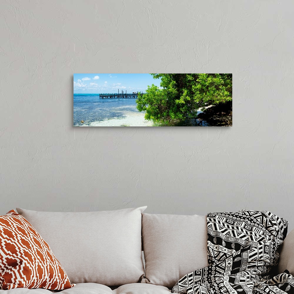 A bohemian room featuring Panoramic photograph of the beautiful, clear blue Caribbean coastline with a pier in the distance...