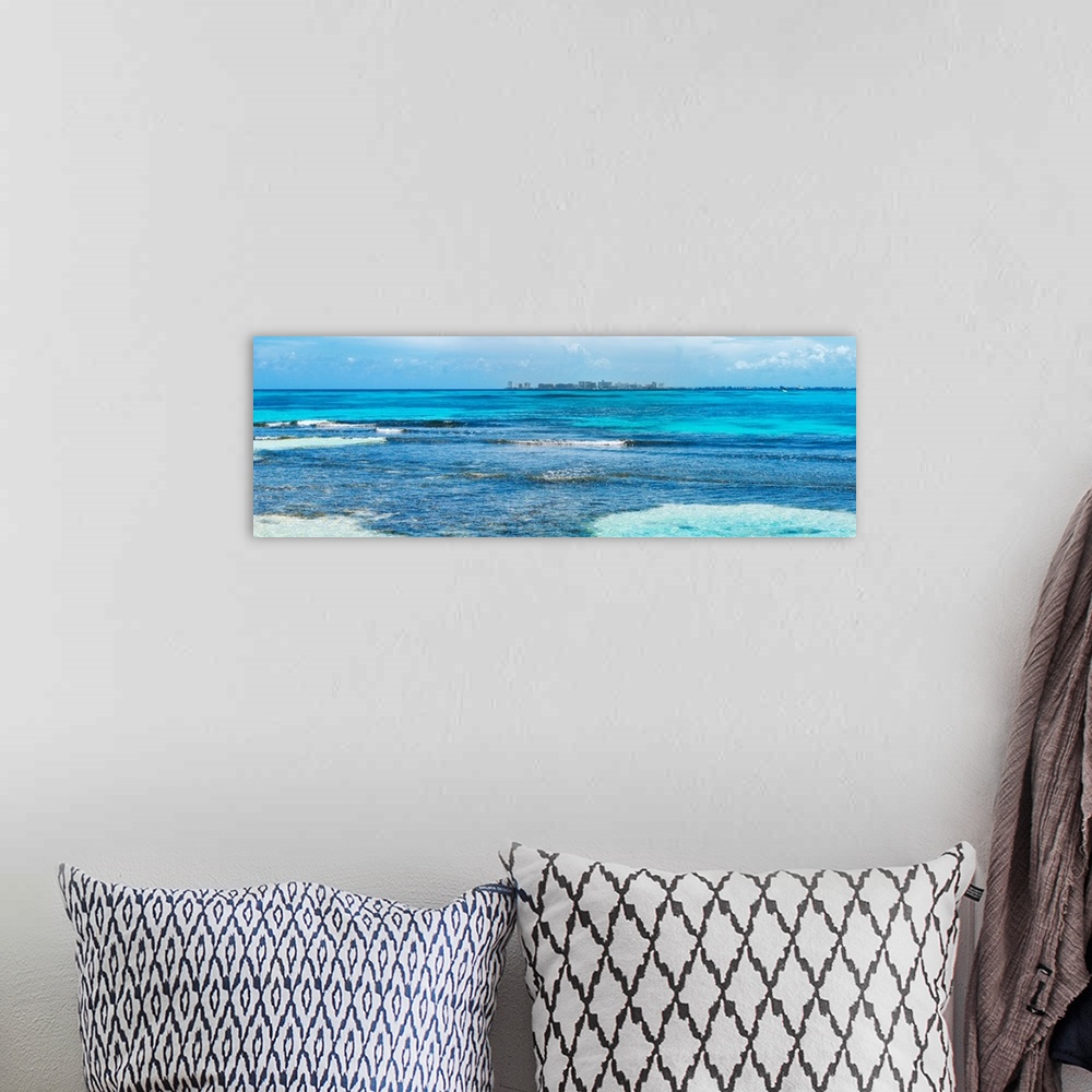 A bohemian room featuring Panoramic photograph of the clear blue Caribbean ocean with the Cancun skyline in the background....