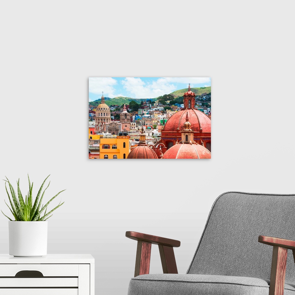 A modern room featuring Cityscape photograph of colorful buildings and several church domes in Guanajuato, Mexico. From t...