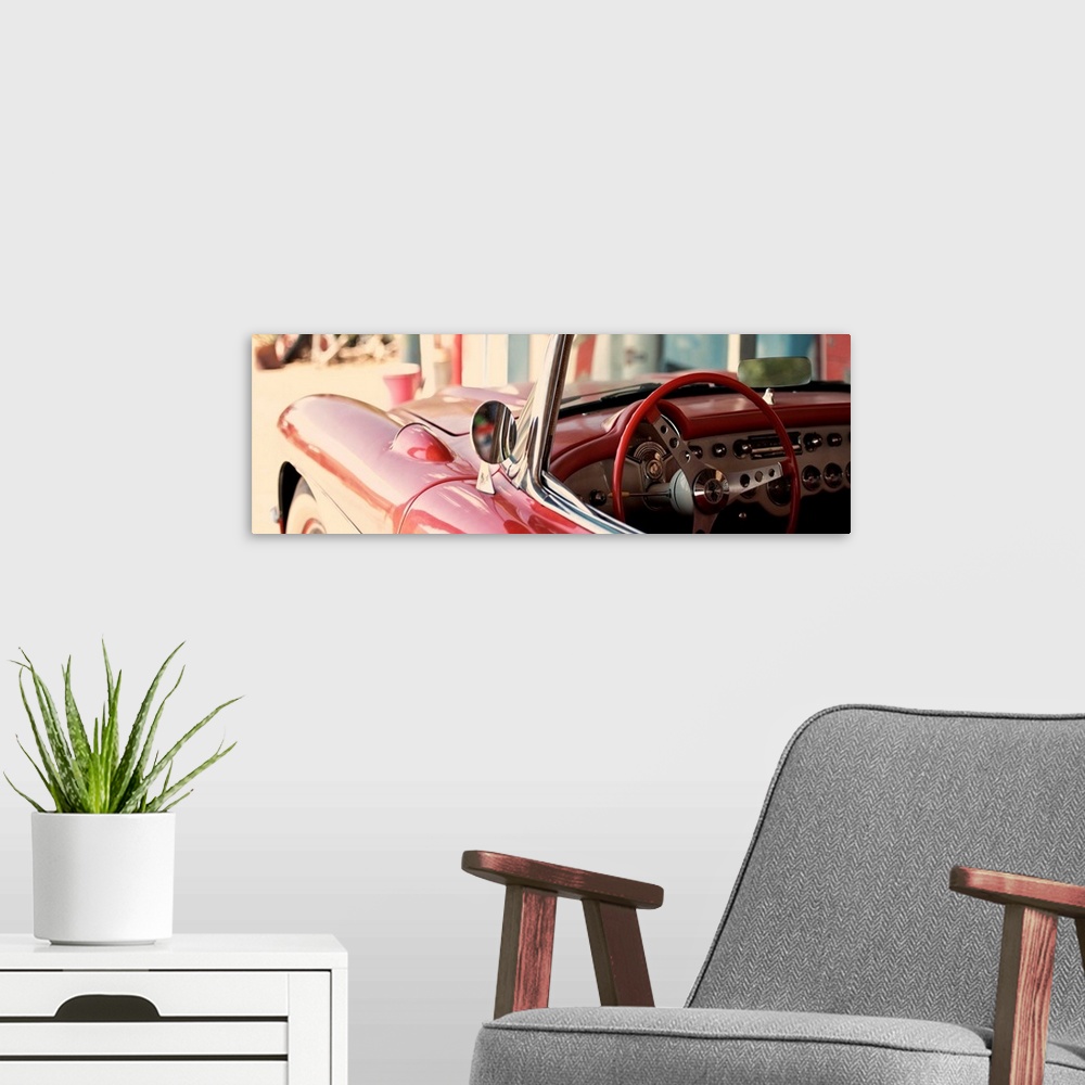 A modern room featuring The cherry red steering wheel stands out in this classic Chevy convertible on the beach.