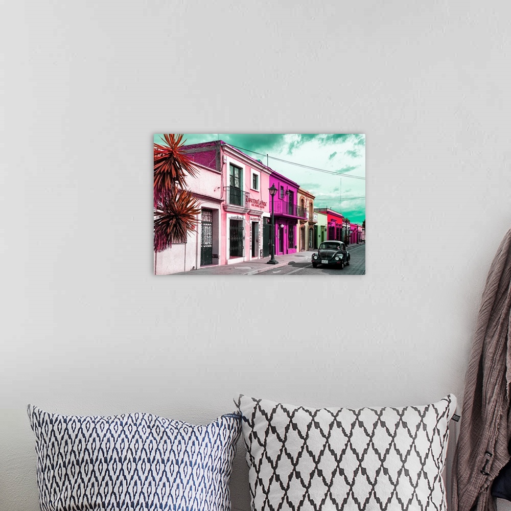 A bohemian room featuring Colorful photograph of pink facades and a black Volkswagen Beetle driving down the street. From t...