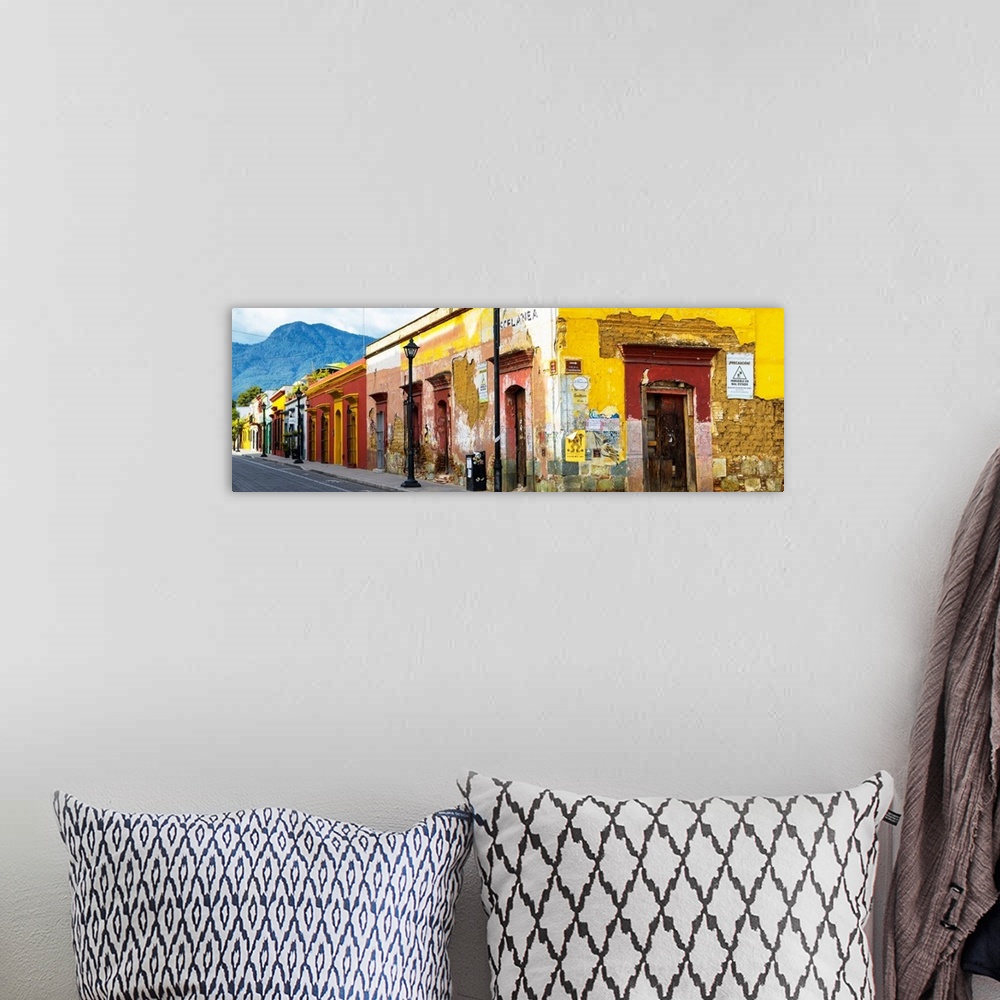 A bohemian room featuring Panoramic photograph of a bright city street in Oaxaca, Mexico, with a view of mountains in the b...