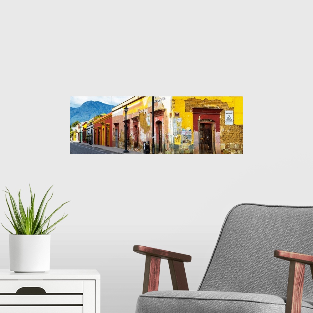 A modern room featuring Panoramic photograph of a bright city street in Oaxaca, Mexico, with a view of mountains in the b...