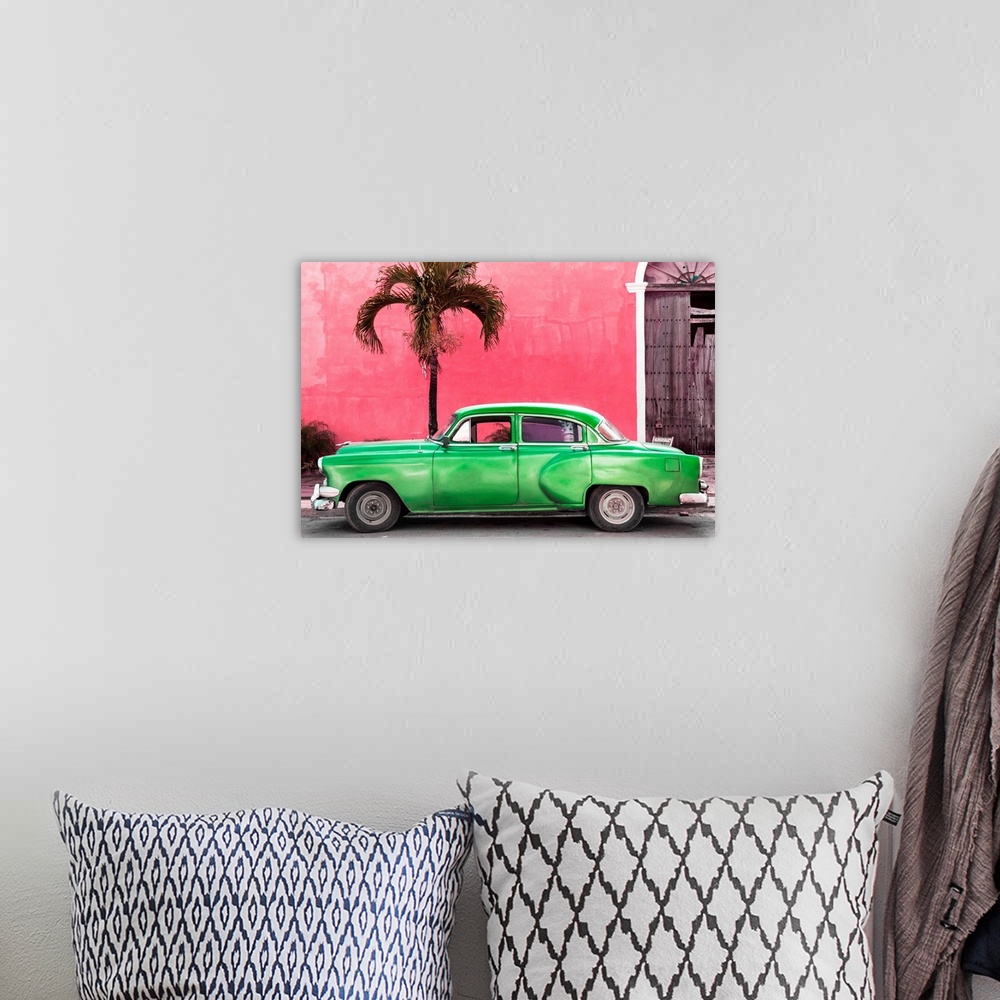 A bohemian room featuring Photograph of a green vintage car parked outside of a bright pink building with a palm tree.