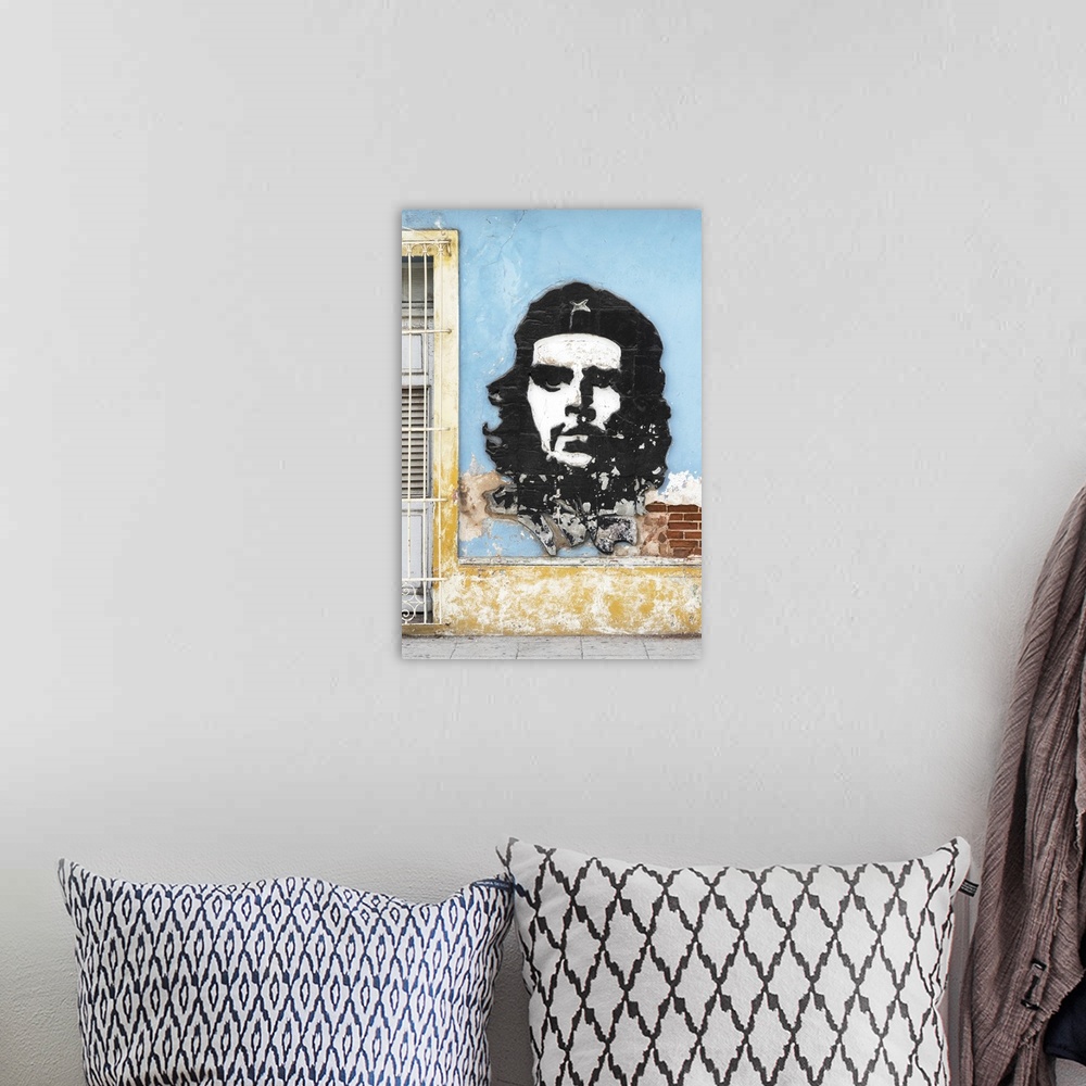 A bohemian room featuring Photograph of a Cuban facade with Che Guevara graffiti on the side of a light blue building, Hava...