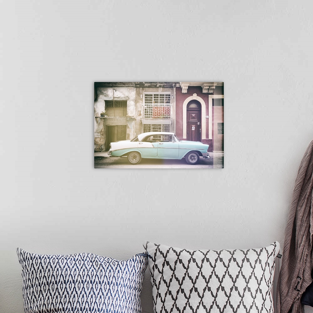 A bohemian room featuring Faded photograph of a turquoise and white vintage card parked on the side of a street in Havana w...