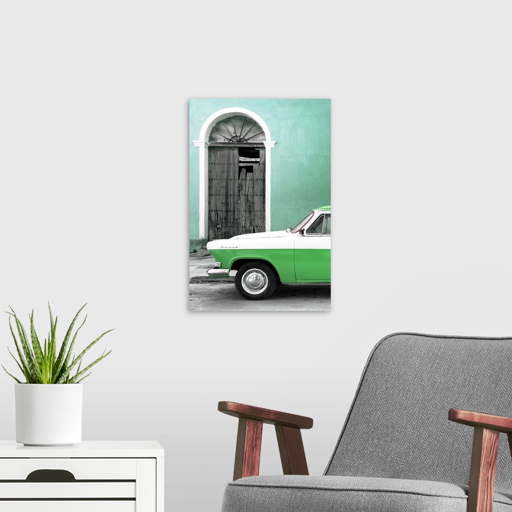 A modern room featuring Photograph of the front of a vintage green and white car outside of a green building with a broke...