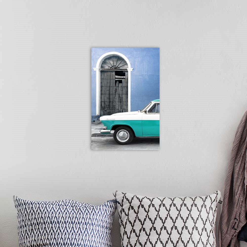 A bohemian room featuring Photograph of the front of a vintage turquoise and white car outside of a blue building with a br...