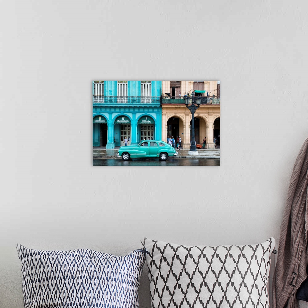 A bohemian room featuring Photograph of a turquoise vintage car parked outside of a bright blue building in downtown Havana.