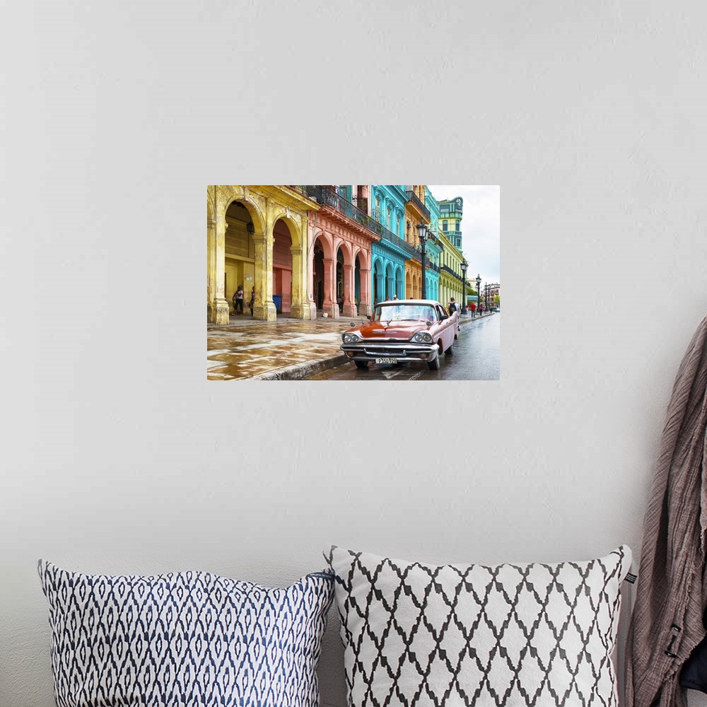 A bohemian room featuring Photograph of a red vintage car parked outside of a colorful building facade in Havana, Cuba.