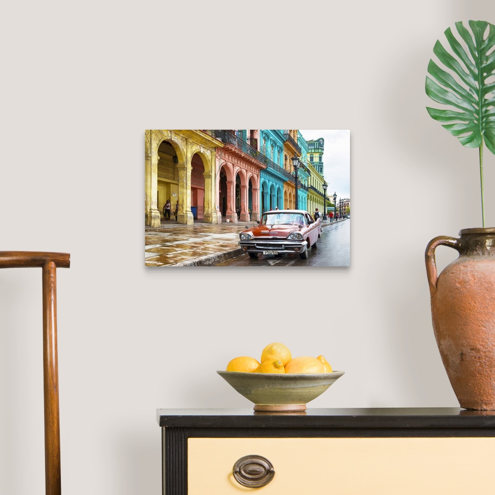 A traditional room featuring Photograph of a red vintage car parked outside of a colorful building facade in Havana, Cuba.