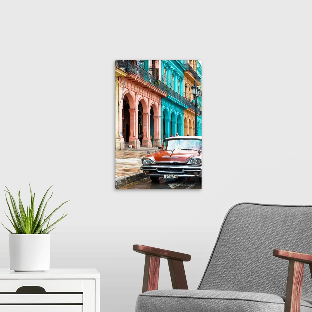 A modern room featuring Photograph of a red taxi parked on the wet streets of Havana with a colorful facade to the left.
