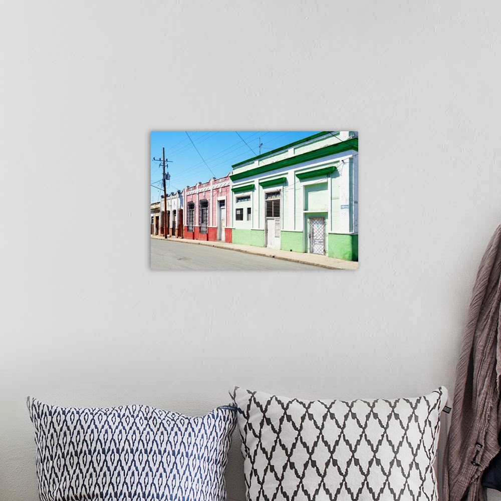 A bohemian room featuring Photograph of a Havana streetscape with colorful facades lining the road.