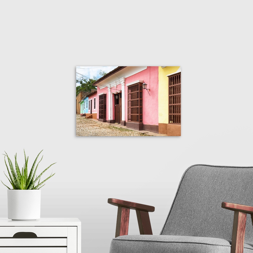 A modern room featuring Photograph of colorful facades lining a Trinidad streetscape.