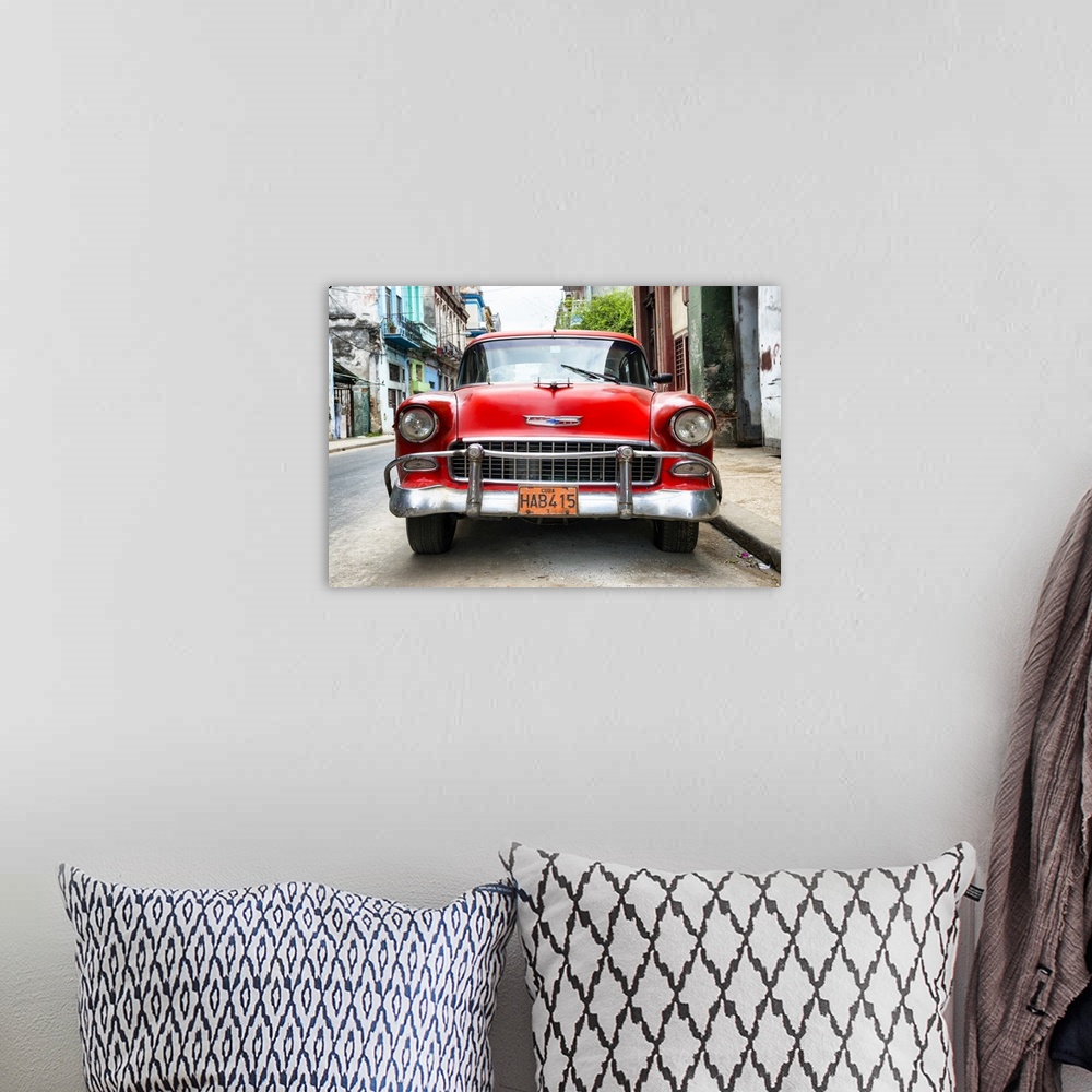 A bohemian room featuring Photograph of the front of a red vintage Chevrolet.