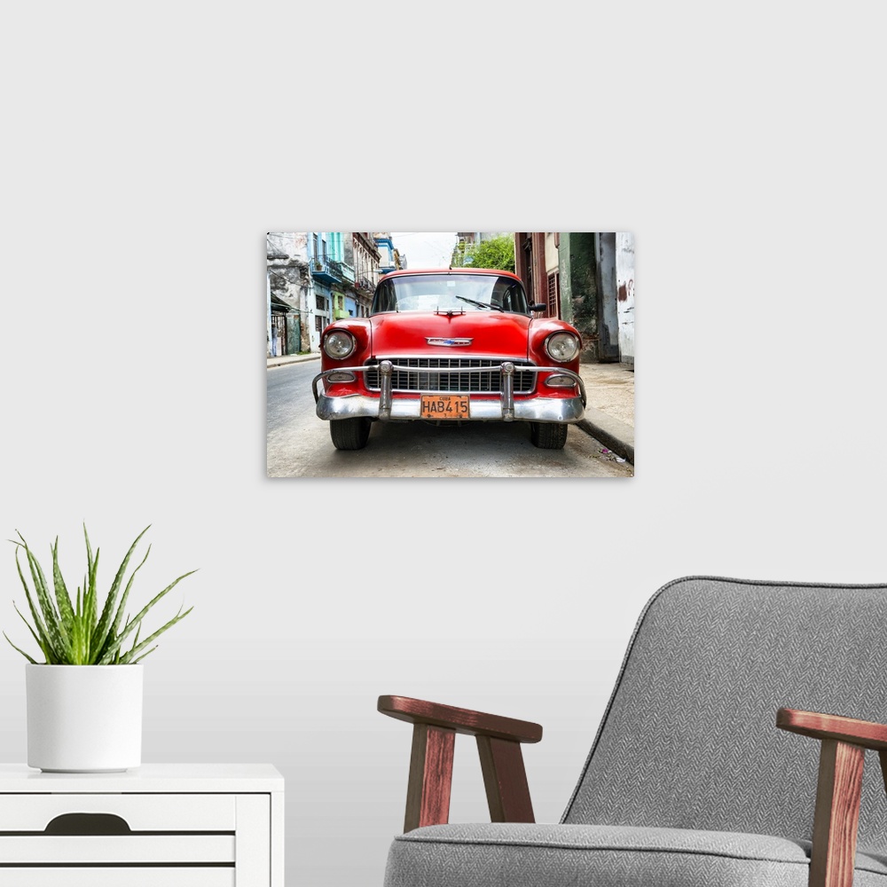 A modern room featuring Photograph of the front of a red vintage Chevrolet.