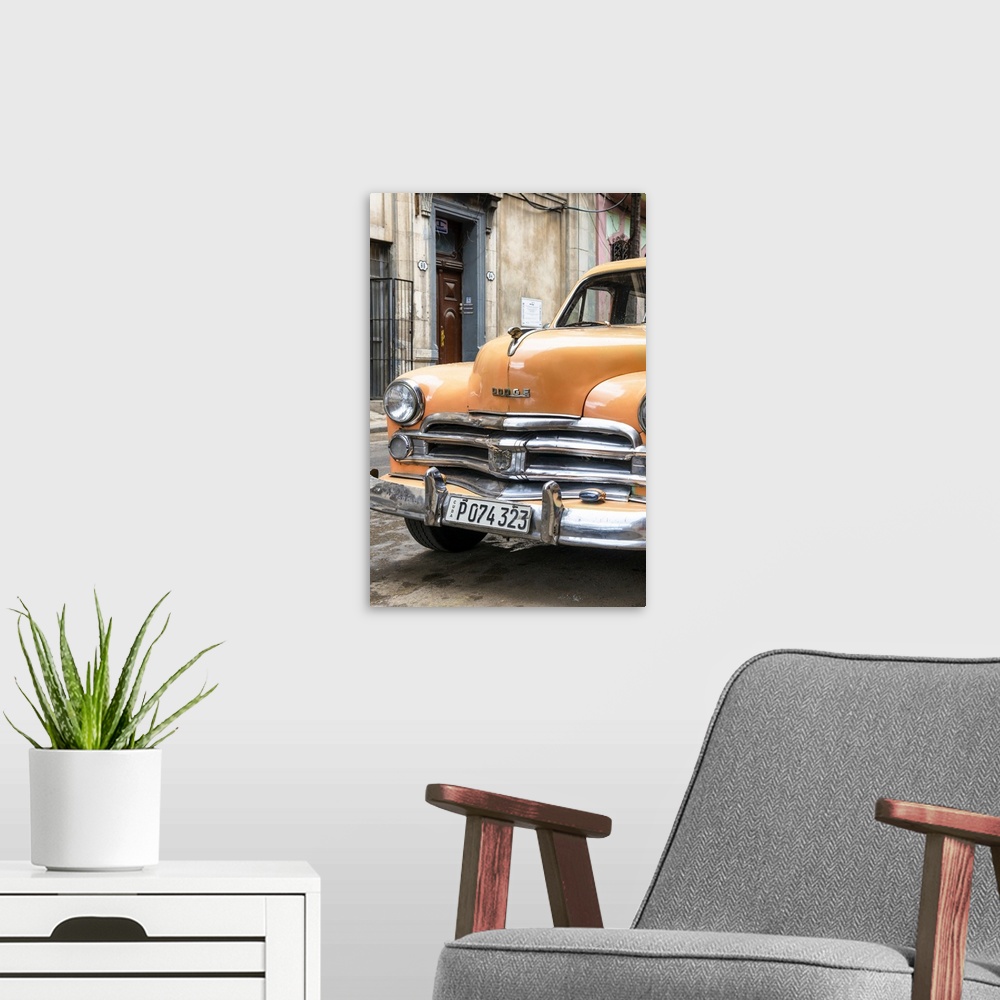 A modern room featuring Photograph of the front of an orange vintage Dodge car parked in downtown Havana.