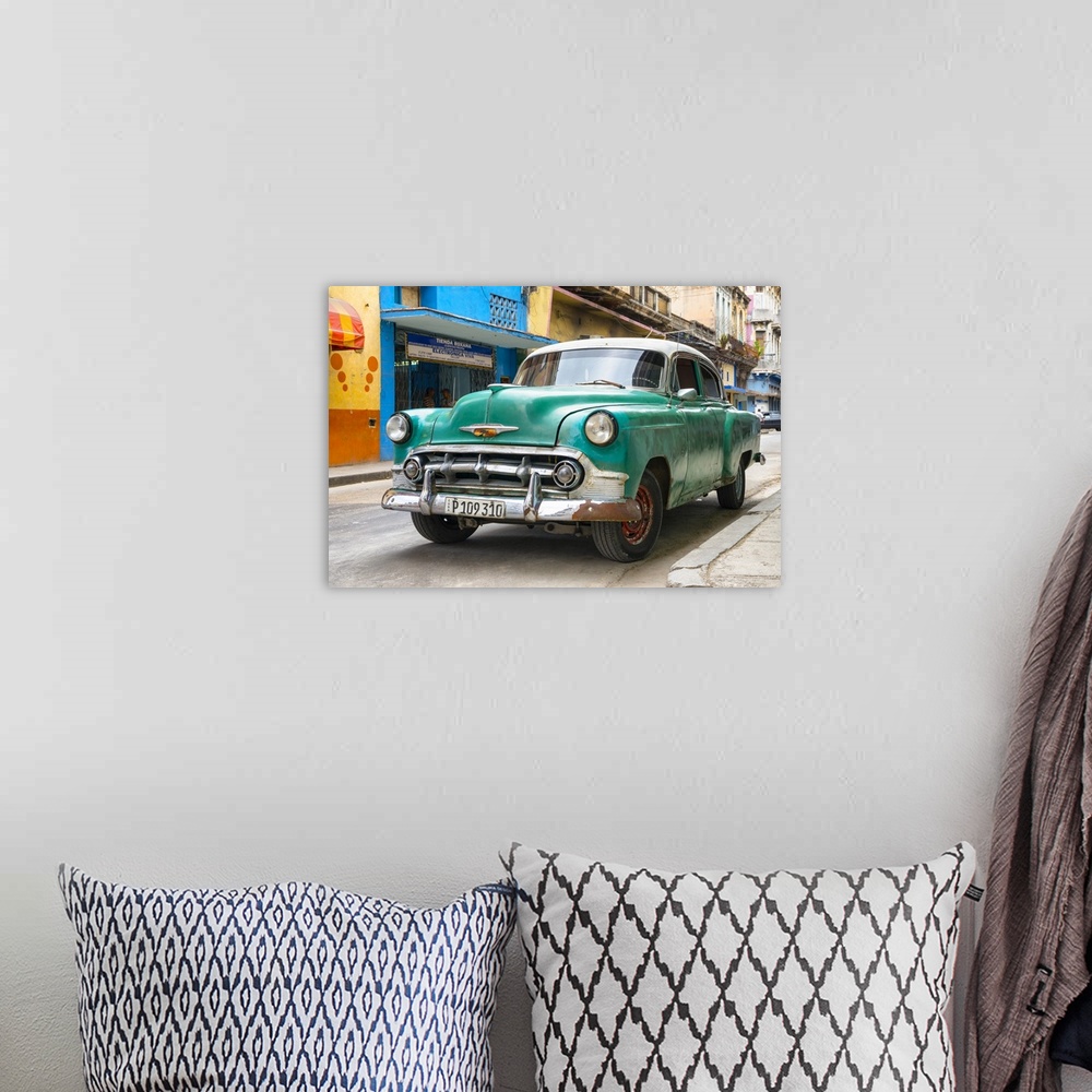 A bohemian room featuring Photograph of the front of a green vintage Chevrolet.