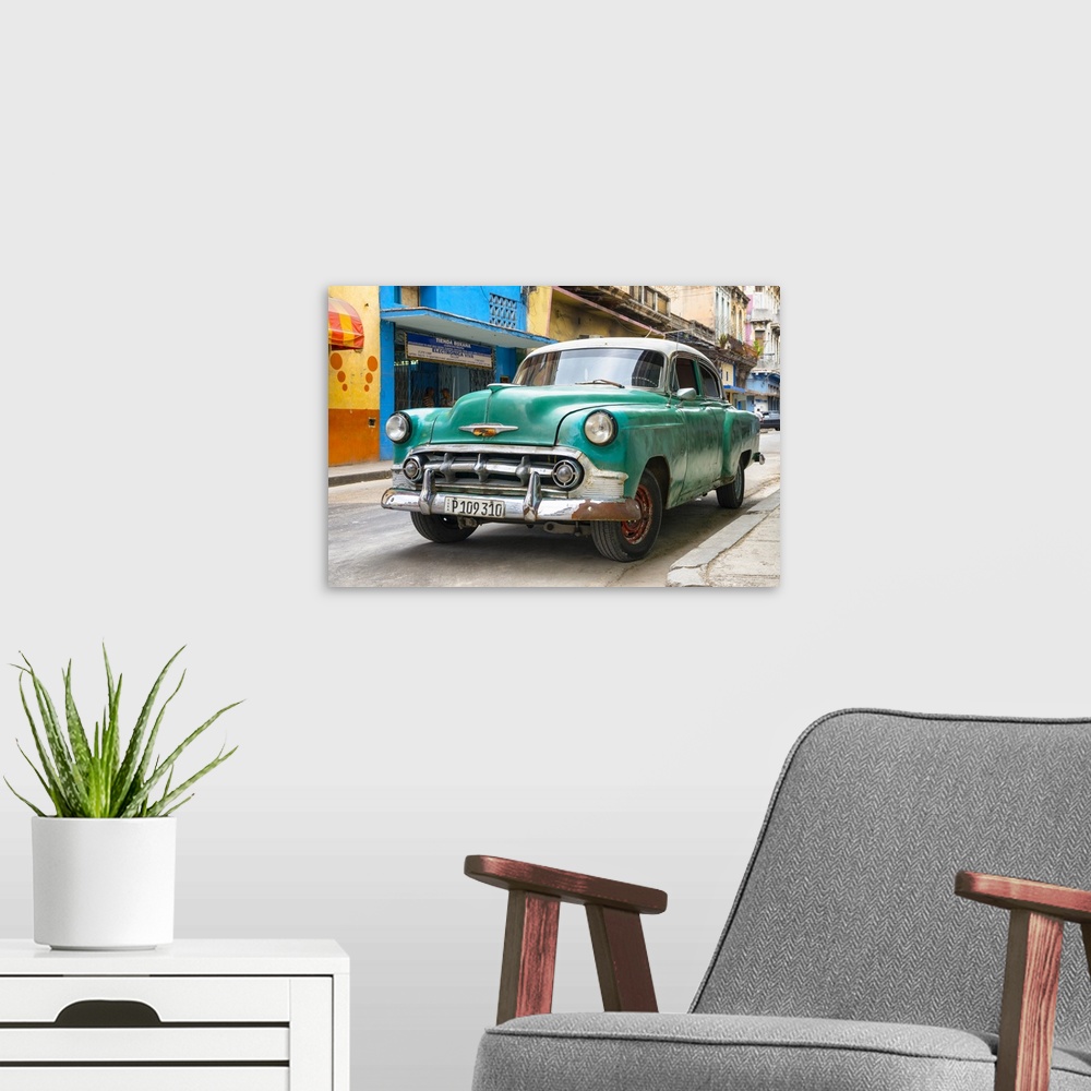A modern room featuring Photograph of the front of a green vintage Chevrolet.