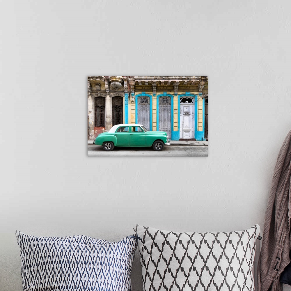 A bohemian room featuring Photograph of a green vintage car with a white roof parked on the street in front of a blue and y...