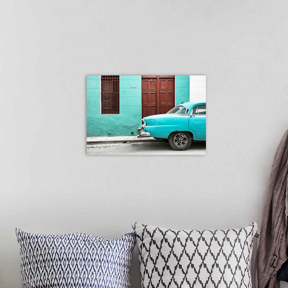 A bohemian room featuring Photograph of the back of a turquoise vintage car next to a matching facade with a dark wooden do...