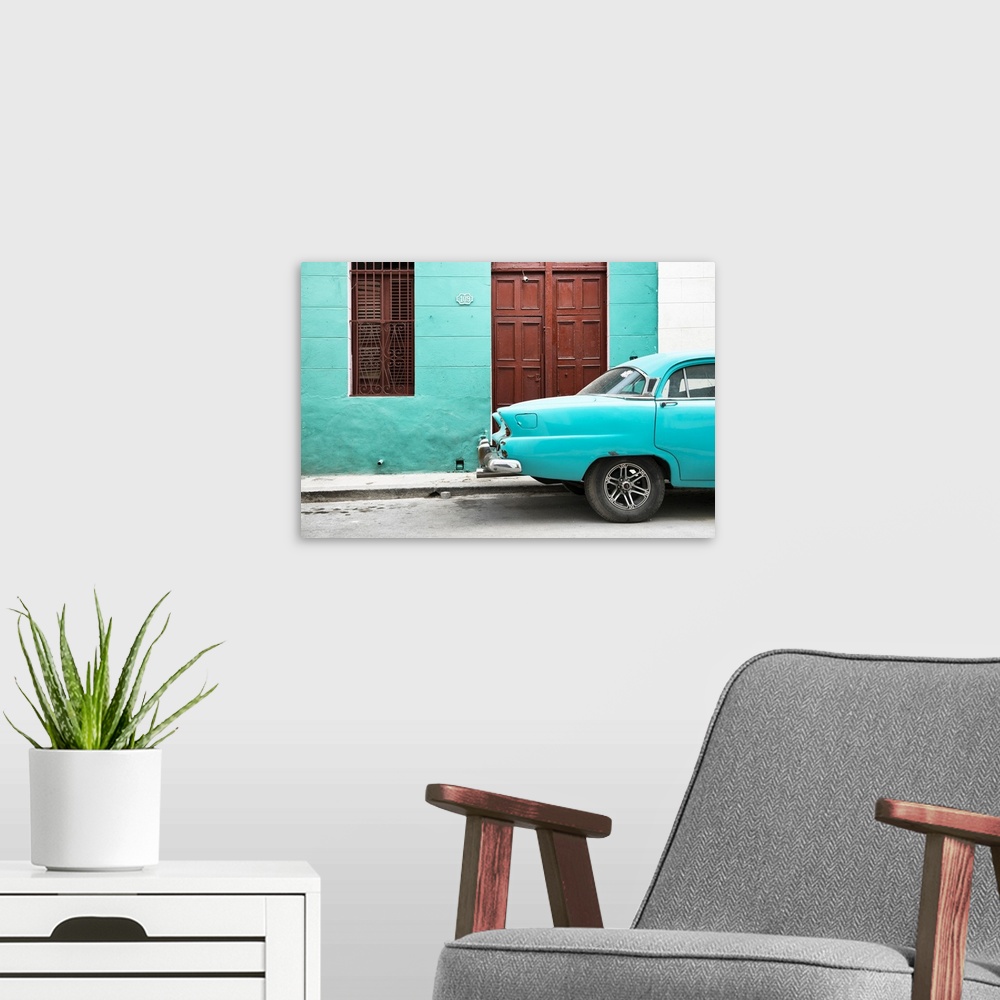 A modern room featuring Photograph of the back of a turquoise vintage car next to a matching facade with a dark wooden do...