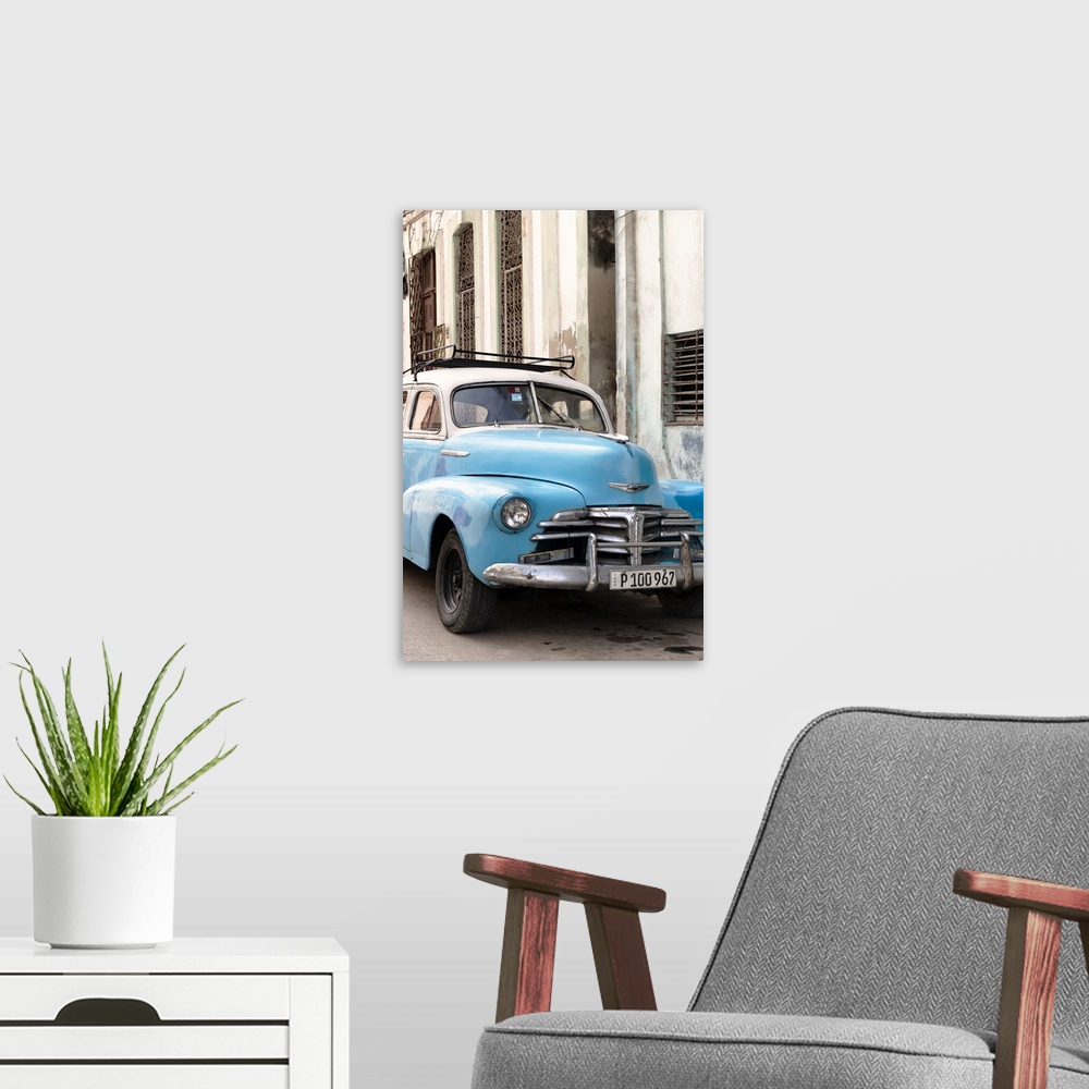 A modern room featuring Photograph of a blue vintage Chevrolet parked outside in the streets of Havana.