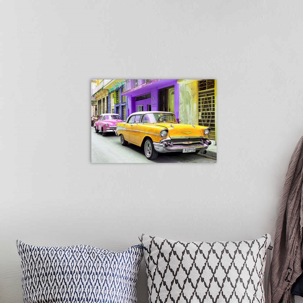 A bohemian room featuring Photograph of a yellow Chevrolet parked outside of brightly colored Cuban facades.