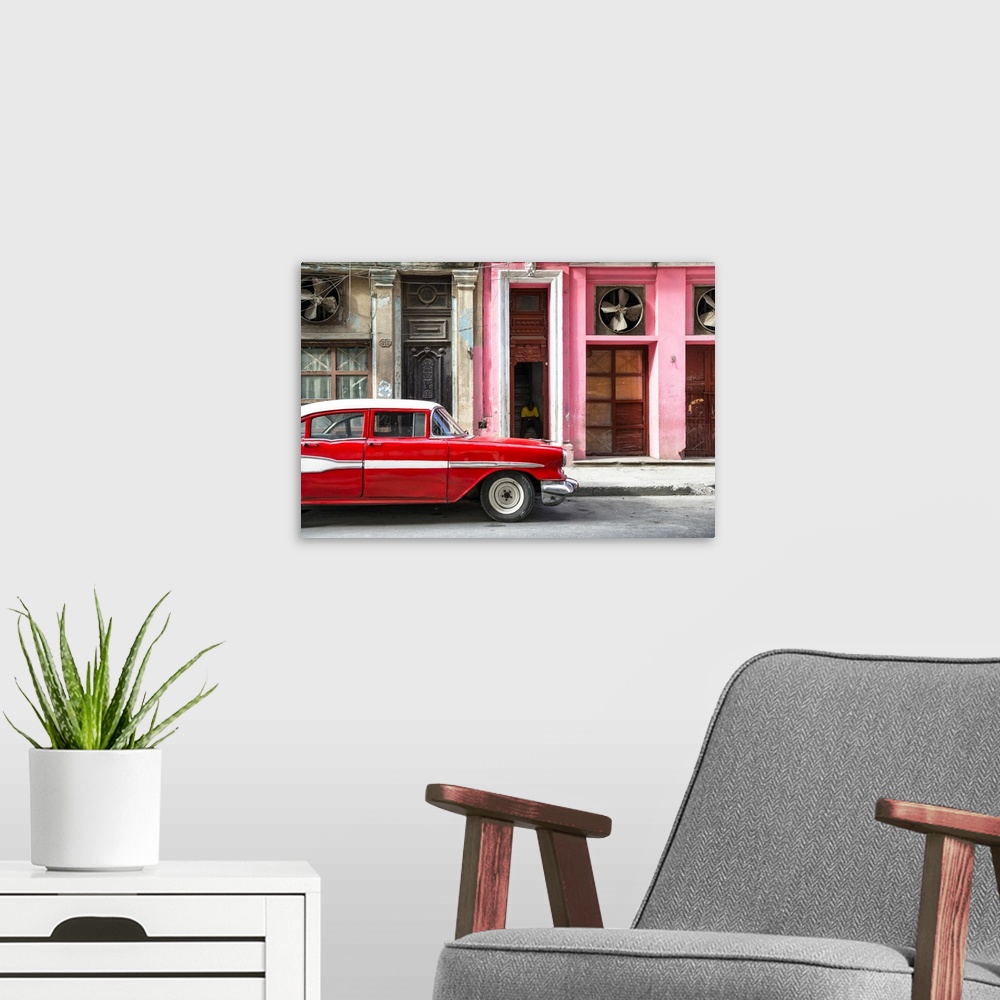 A modern room featuring Photograph of a classic old red car in front of a pink facade in Havana, Cuba.