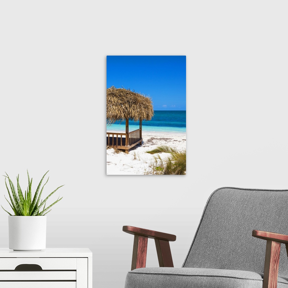 A modern room featuring Relaxing photograph of a cabana on the white sands of a Cuban beach with beautiful blue water in ...
