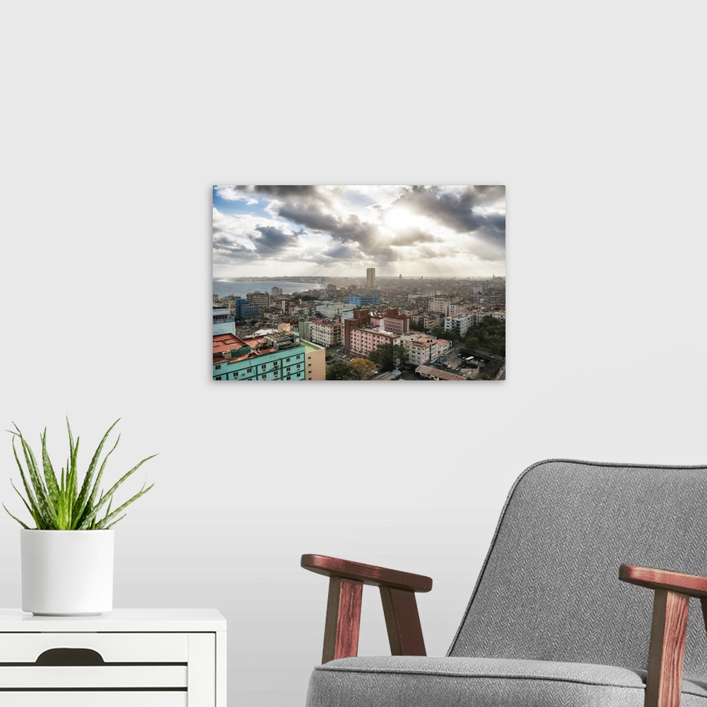 A modern room featuring Photograph of the sun beaming through the clouds of the city of Havana.
