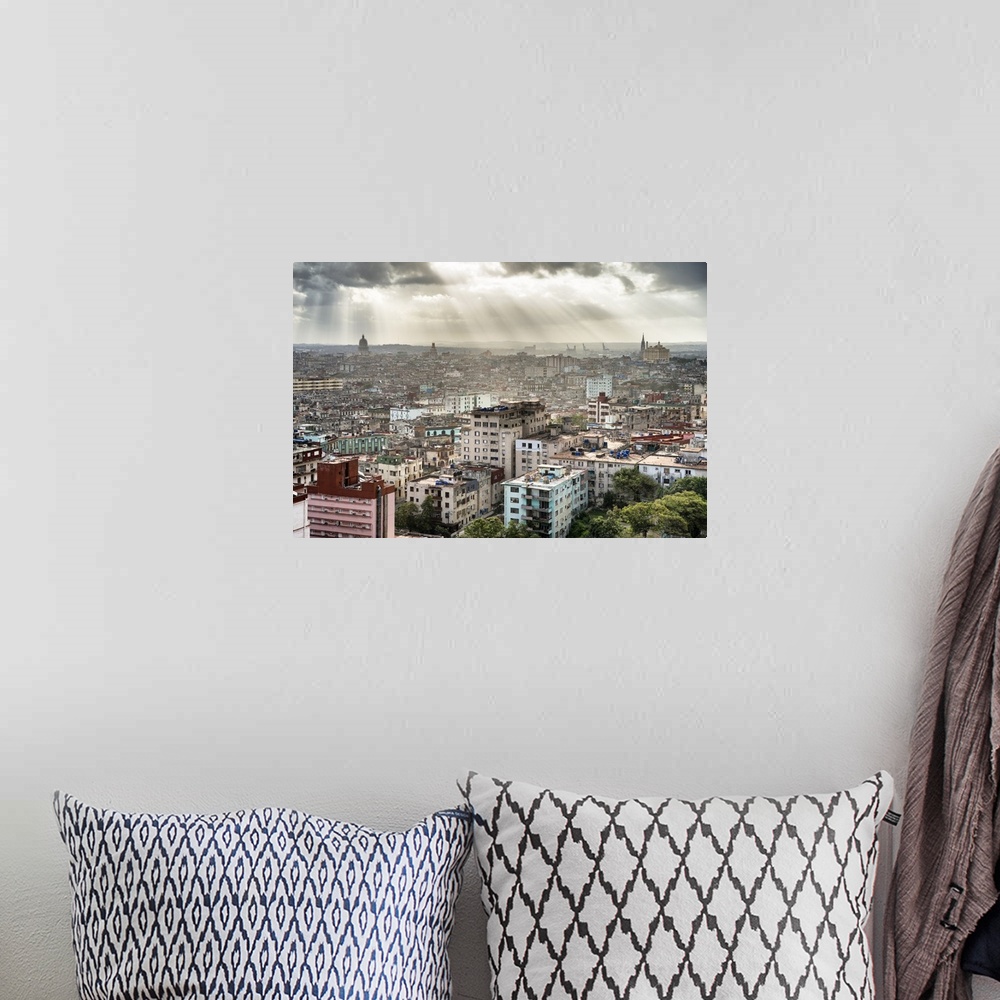A bohemian room featuring Beautiful photograph of the sun beaming through the clouds over the city of Havana.